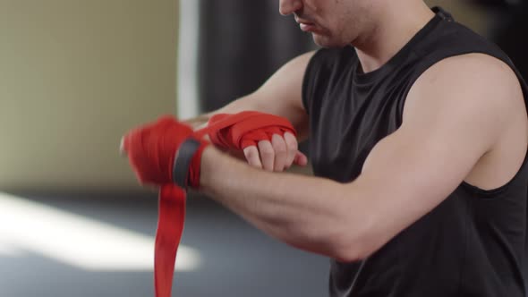 Strong Boxer Wrapping Hands before Fighting