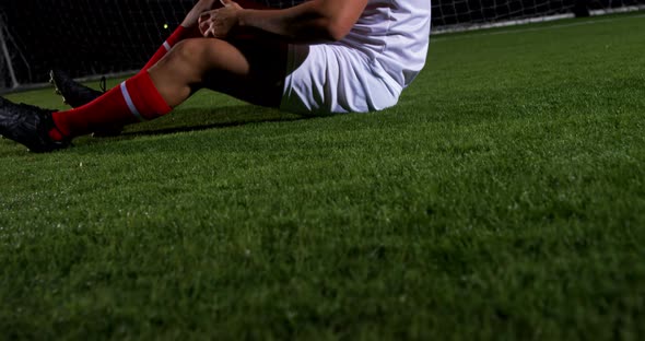 Injured soccer player lying 4k
