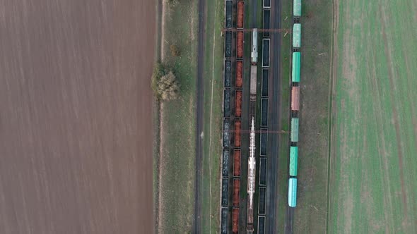 An Aerial Drone View of Railway Carriages at the Station Surrounded By Fields