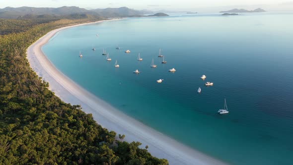 Whitehaven Beach Whitsundays  aerial tracking backwards with boats, Queensland