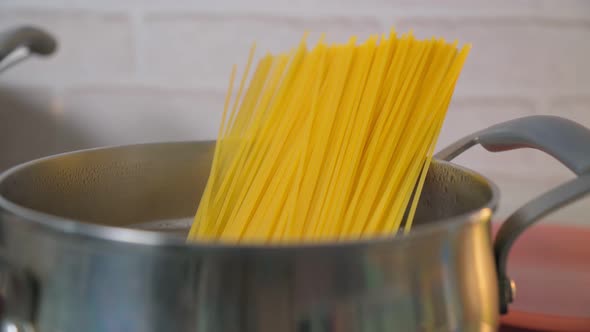 Cooking Spaghetti in Boiling Water Cooker on a Kitchen