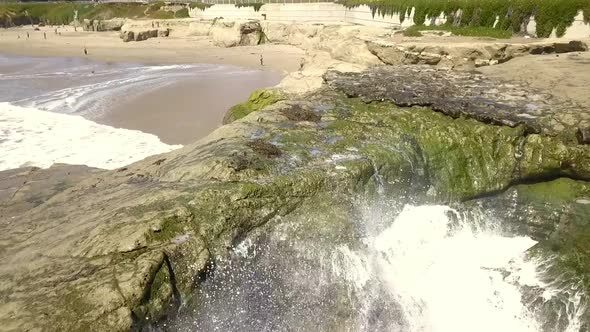 Wave splash on rocks on beach. An almost empty beach. Fantastic aerial view flight pull in drone foo
