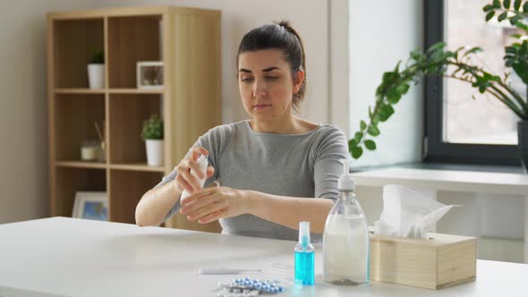 Woman Spraying Hand Sanitizer at Home