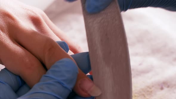 Manicurist is Forming Nails of Client with Nail File