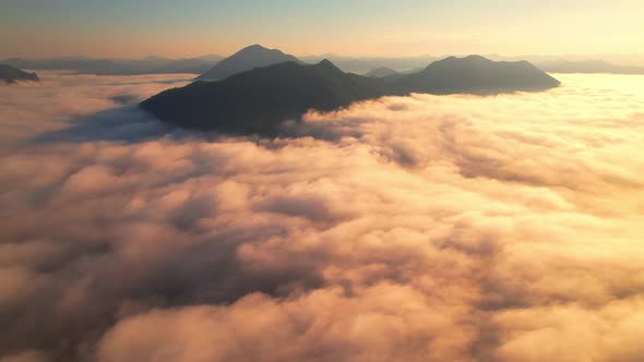 4K Aerial video Beautiful sunrise above dense clouds and fog in the morning