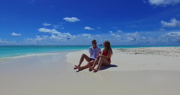 Romantic couple on honeymoon vacation live the dream on beach on summer white sandy 4K background