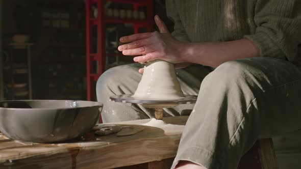 Woman Is Working With Raw Clay On Potter's Wheel