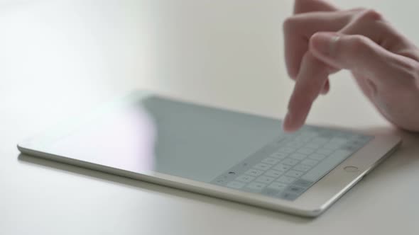 Close Up of Finger Typing on Digital Tablet