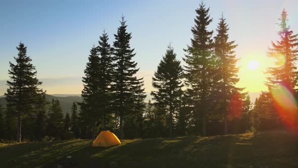 Aerial View of Tourist Camping Tent on Mountain Campsite at Bright Sunny Evening