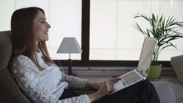 The Woman To Make A Phone Call. She Is Talking On Laptop And Gesture 