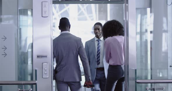 Business people getting in the elevator at modern office 4k