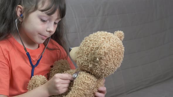 Playing doctor with teddy. 