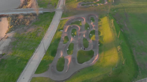 Aerial top-down forward over huge park near Vasco da Gama Bridge at sunrise, Lisbon. Portugal