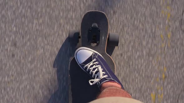 Riding Longboard Closeup Male Feet in Sneakers