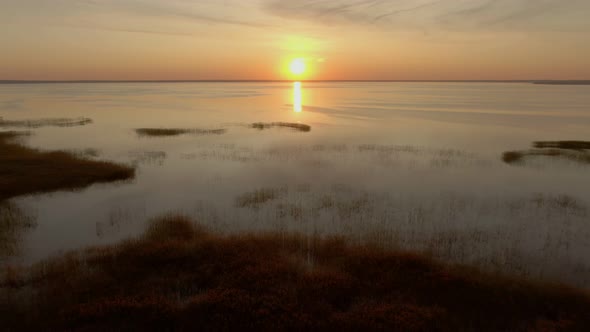 Aerial Shot of Colorful Sunset Over a Large Beautiful Lake