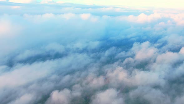 4K Drone Flying through the clouds at dusk or dawn. Aerial top cloudscape