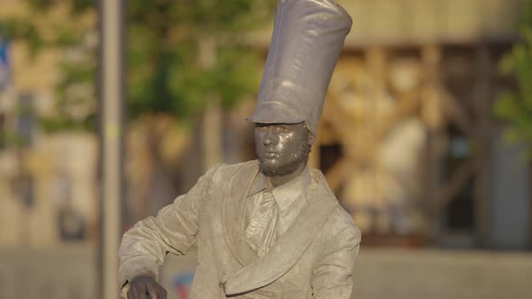 Street artist dressed as silver statue