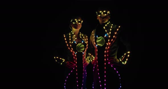 Colorful Lights All Over the Clothes of Two Performers on Stage, 