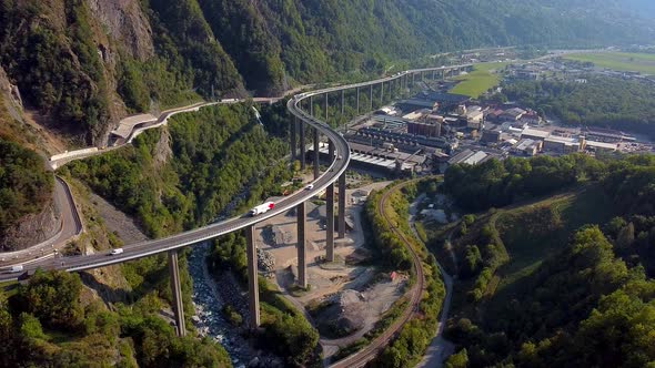 Aerial locked shot of an industrial area and huge bridge in the mountains. Viaduct Égratz de Passy,