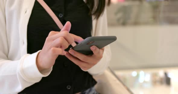 Woman use of mobile phone in shopping mall