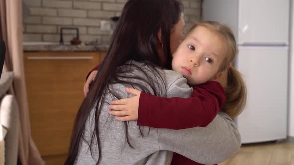 A Sad Daughter Hugging Mother at Home