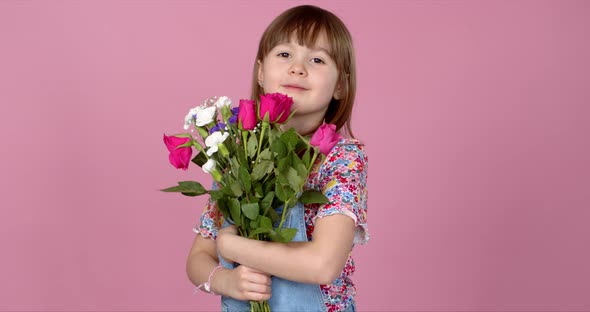 Sweet Adorable Young Little Girl Holding Bunch of Fresh Spring Flowers