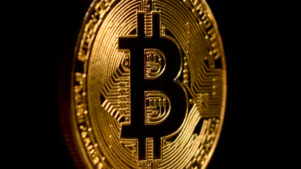 Gold Bitcoin Rotates on a Black Background