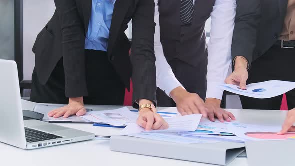 close up Business person reviewing Charts document for business project coworker