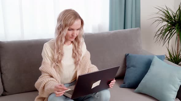 Young Beautiful Woman Using a Laptop Computer at Home