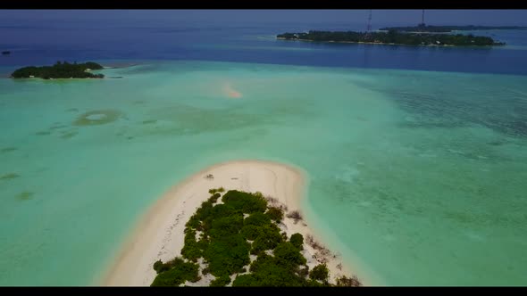 Aerial drone travel of idyllic shore beach break by blue sea with white sandy background of a dayout