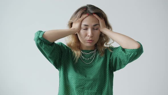 Slow Motion of Exhausted Young Woman Touching Head Suffering From Migraine