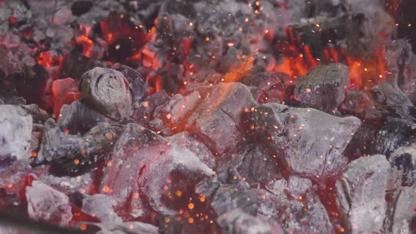 Burning coals mixed by iron stick