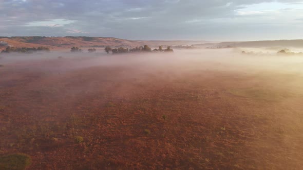 Aerial Drone View of Sunrise Over Misty River