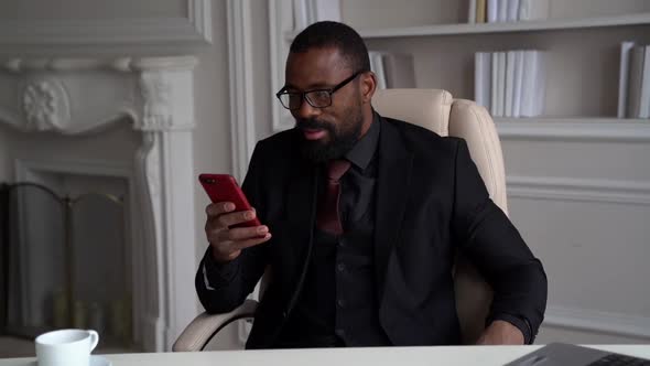 Handsome Afro-american Man Is Dressed Black Business Suit Is Calling By Mobile Phone From His Home