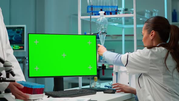 Researcher Looking at Chroma Key Display in Modern Equipped Lab