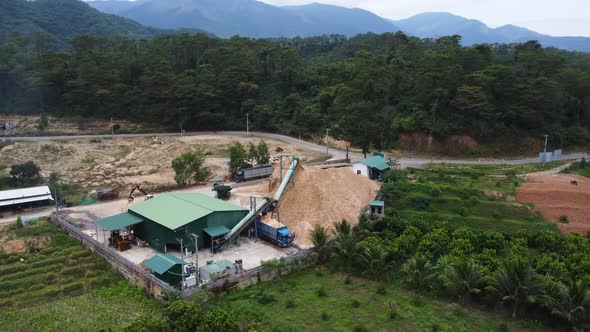 Logging and timber processing place near Vietnamese forest. Aerial orbit view