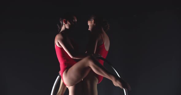 Athletic Gymnasts are Spinning on a Hoop Performance in the Studio