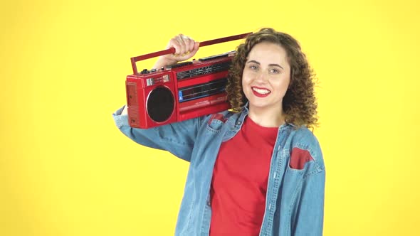 Woman Enjoying the Music and Dancing with the Red Boombox on Her Shoulder, Retro Style, Slow Motion