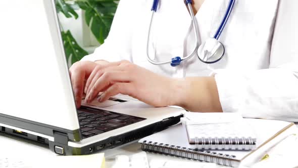 Female doctor work on laptop