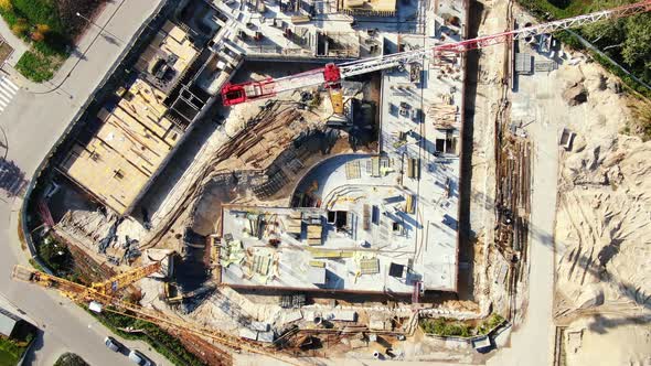 High building construction site. Big industrial tower crane with blue sky amd cityscape on backgroun