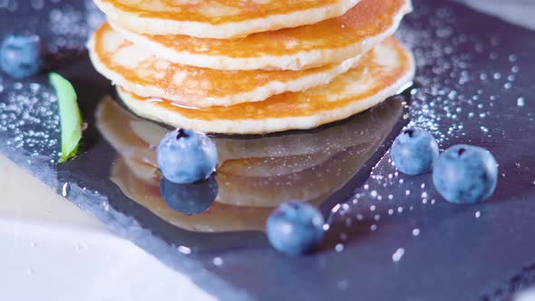 Blueberries on Top of Pancakes with Syrup Around