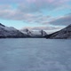 Frozen lake filmed from above with a drone, mountains in the background - VideoHive Item for Sale