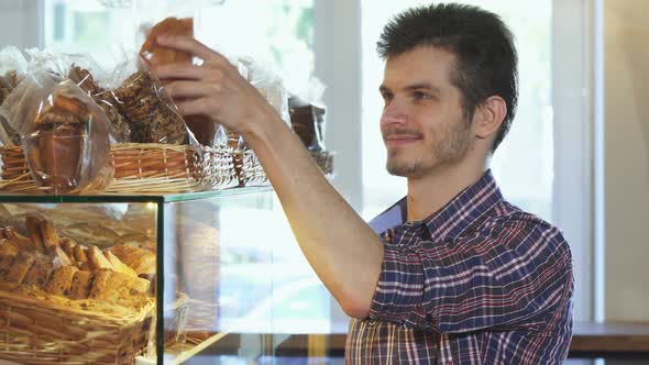 Attractive Young Man Buying Cookies at the Bakery