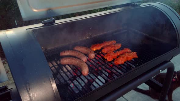 Looking at the Sausages and Chicken Sate getting the heat and smoke of the BBQ