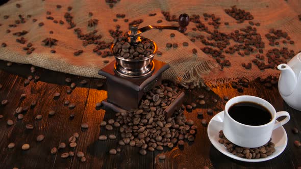 Teapot and Cup Coffee on Saucer with Grains of Coffee