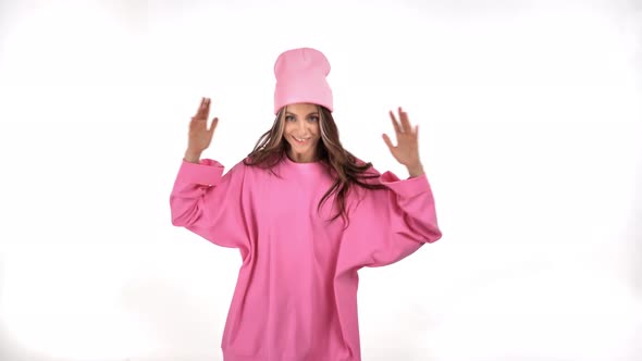 Cheerful Trendy Woman in Hipster Pink Pullover and Hat Dancing Funky Isolated