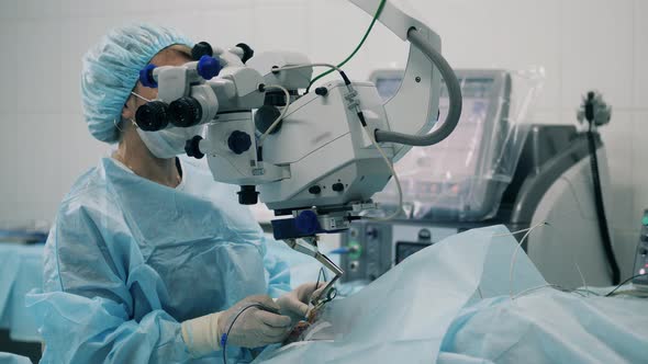 Surgeon is Observing Eye Operation Through the Medical Device