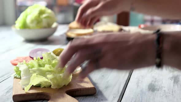 Hands and Board with Vegetables.