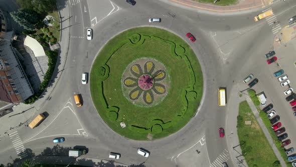 Aerial View of Roundabout Road with Circular Cars in Small European City at Sunny Day