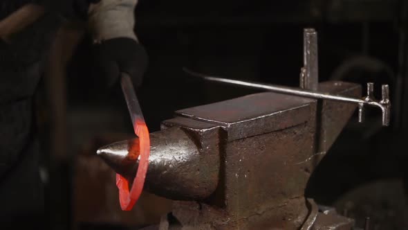 Close Up Shot of a Blacksmith's Hand, Men Make a Horseshoe Made of Steel